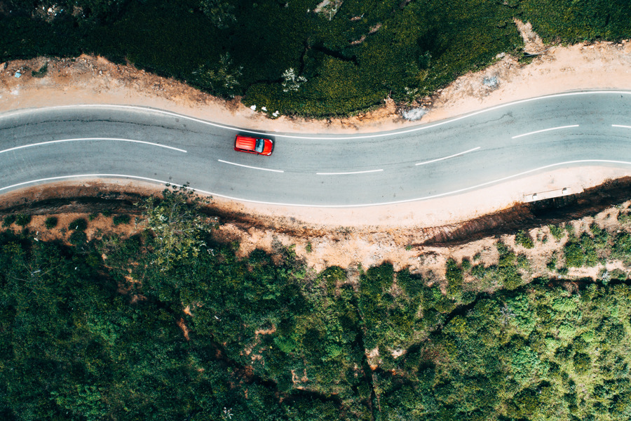 Aerial view on red car on the road