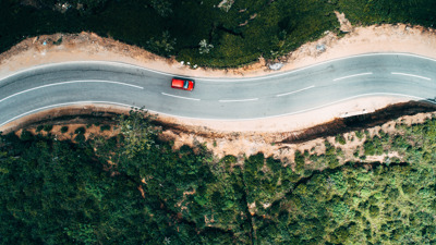 Aerial view on red car on the road